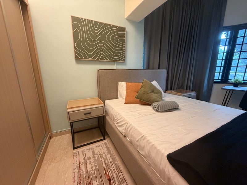 Bedroom with a made-up bed, sliding wardrobe, two bedside tables, rug and a window
